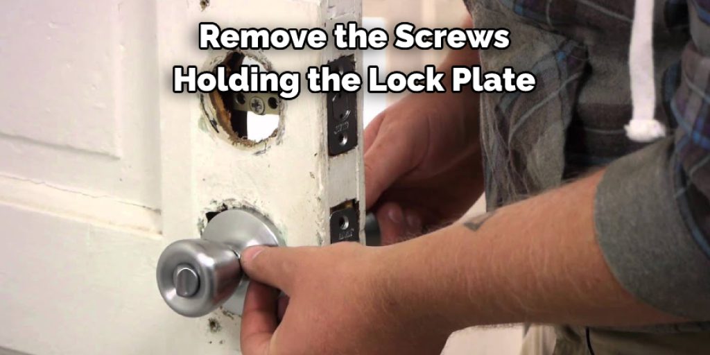  Remove the Screws  Holding the Lock Plate