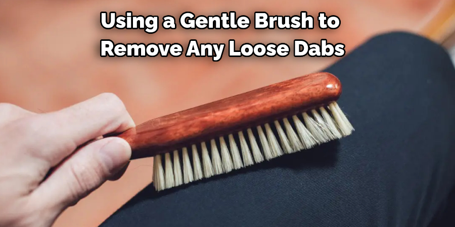 Using a Gentle Brush to Remove Any Loose Dabs
