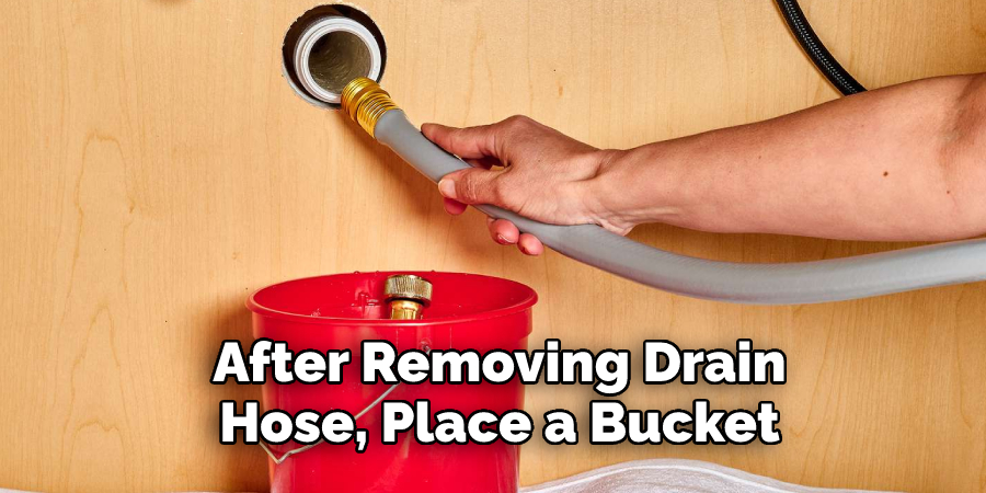 After Removing Drain 
Hose, Place a Bucket