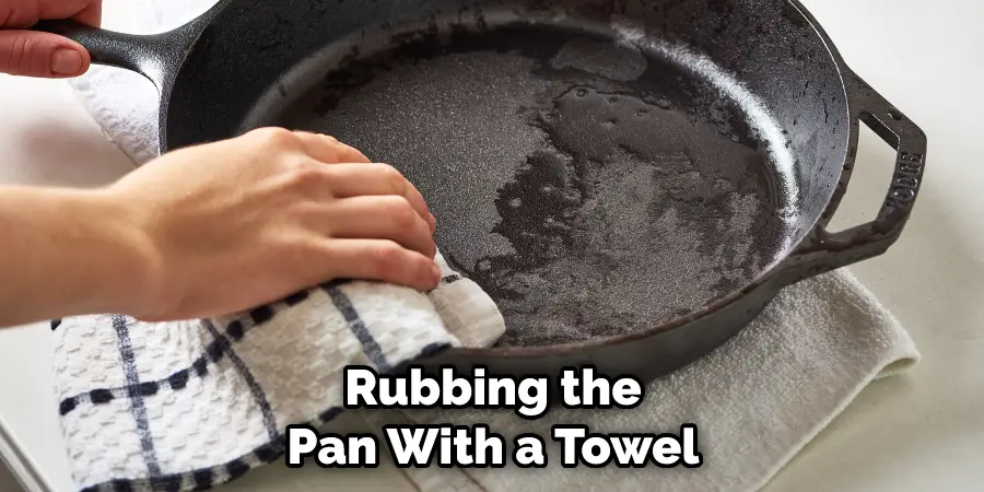 Rubbing the Pan With a Towel