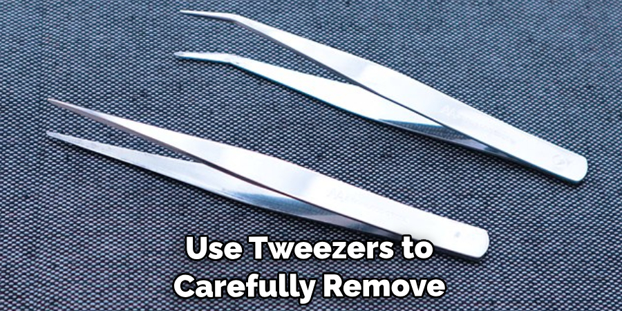 Use Tweezers to Carefully Remove the Parts