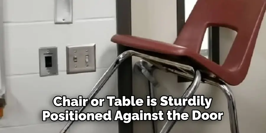 Chair or Table is Sturdily Positioned Against the Door