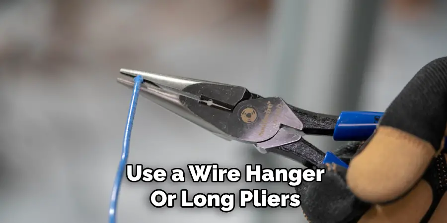 Use a Wire Hanger
Or Long Pliers