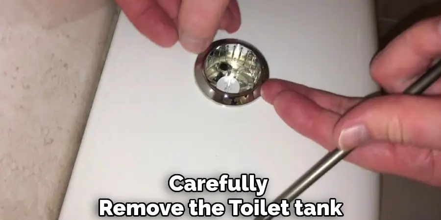 Carefully remove the toilet tank
