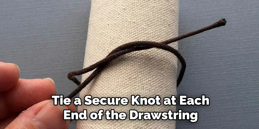Tie a Secure Knot at Each
End of the Drawstring