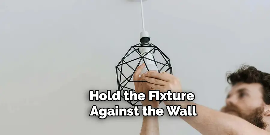 Hold the Fixture
Against the Wall