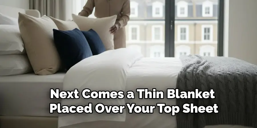 Next Comes a Thin Blanket 
Placed Over Your Top Sheet
